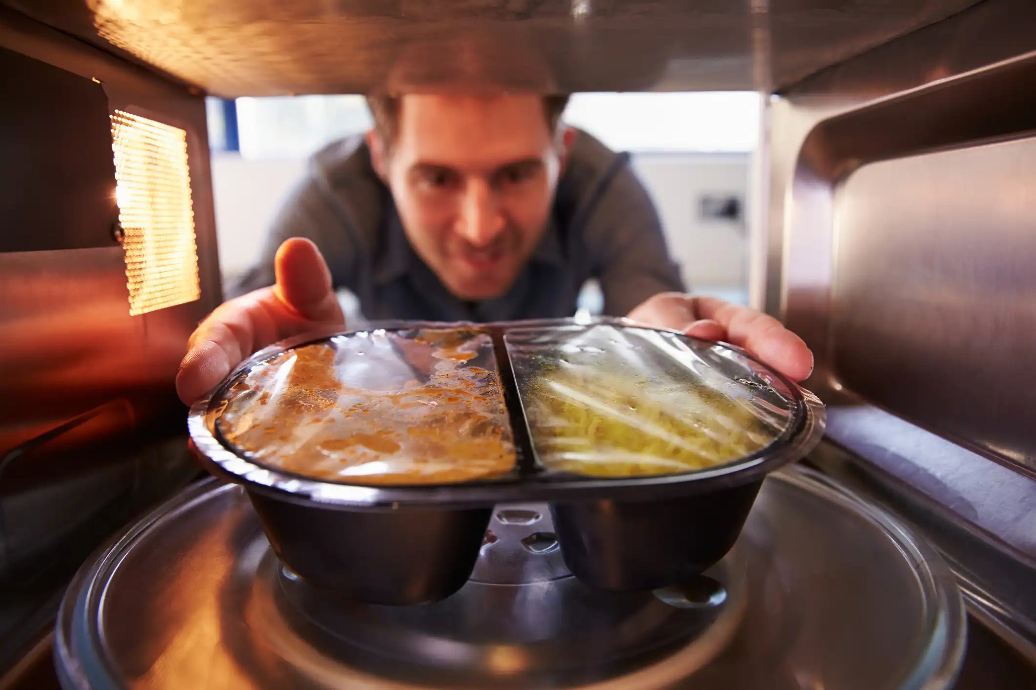 Food and Beverage Industry - Man microwaving foods